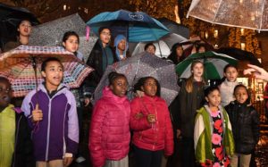 group singing with umbrellas